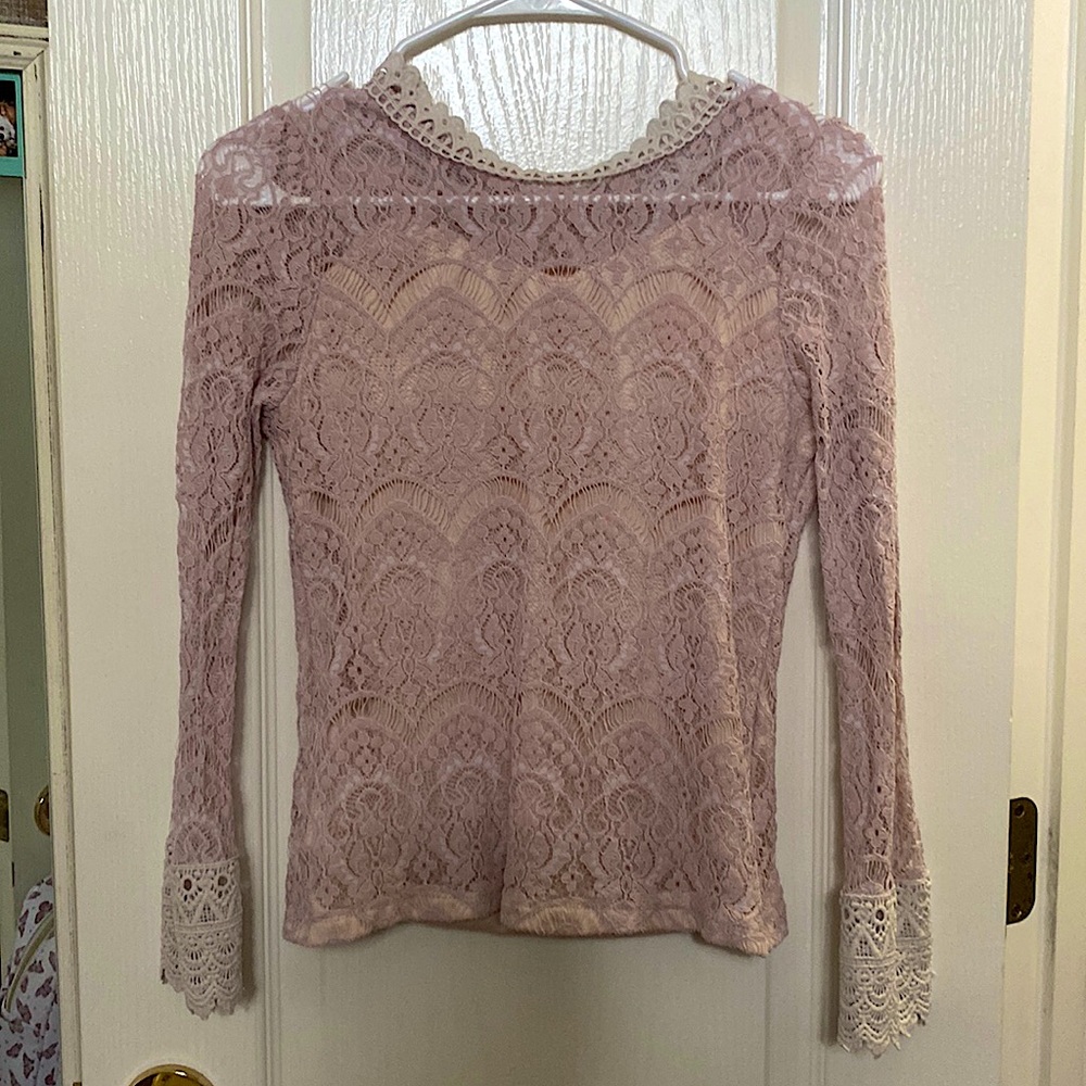 Pink lace shirt with a matching color tank top underneath.
